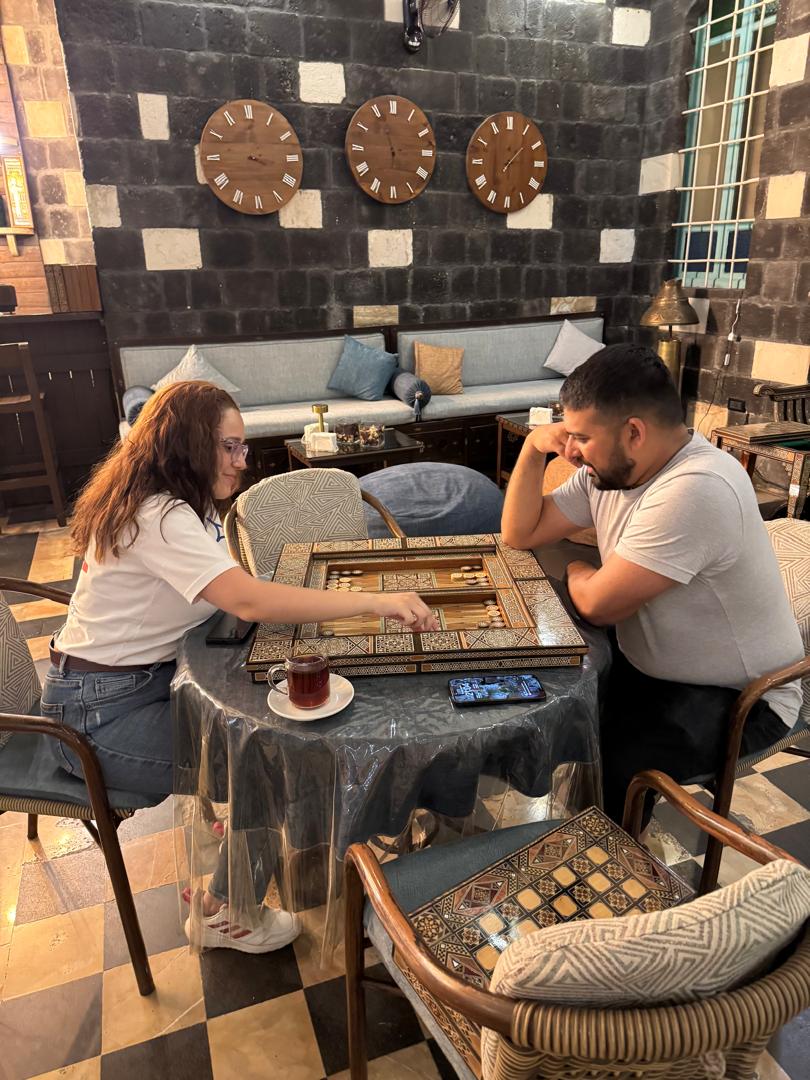 mary plays backgammon with a tourist at via recta