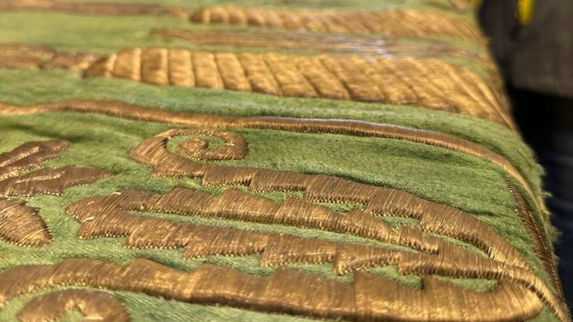 A close-up showing the raised pattern and reflective metallic threads