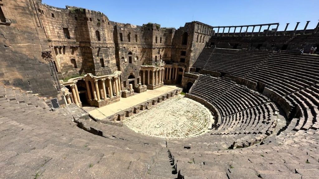 Discover Bosra, Syria’s black basalt city, where a Roman theatre, ancient streets, churches and mosques reveal over 2,000 years of history.